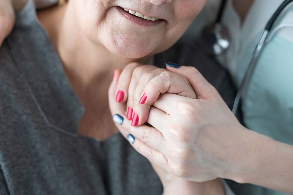 Hospice care - senior woman with caregiver
