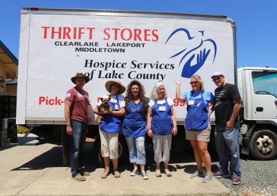 employees and volunteers in front of the hospice services delivery truck